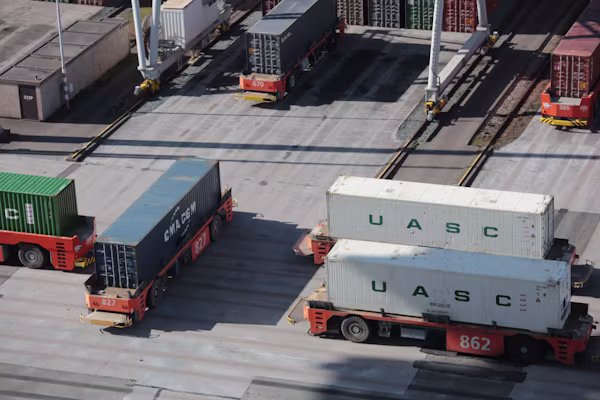 Container terminal with automated transporters moving freight