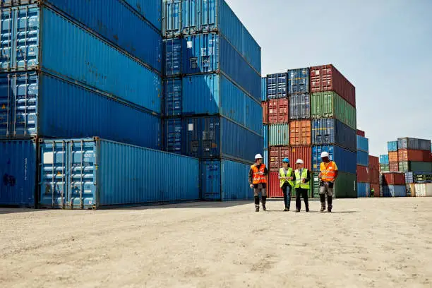 Logistics team in hi-vis at a container depot